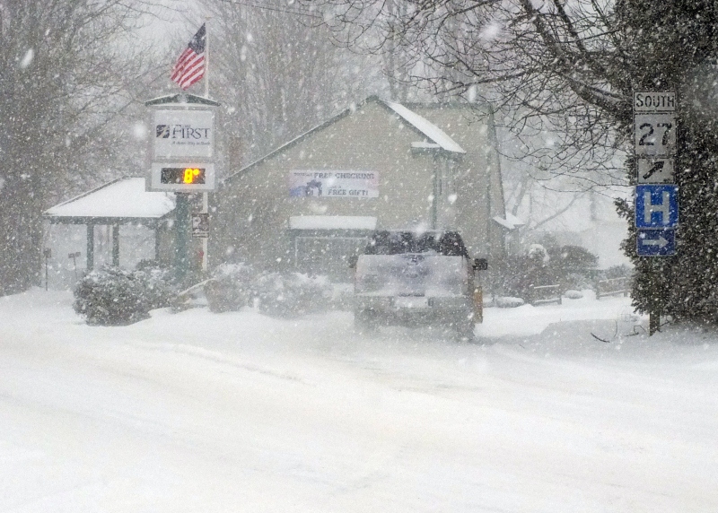 A snowplow turns on to Oak Street in Boothbay Harbor near The First bank at 9 a.m. Friday morning as snow starts to pile up. GARY DOW/Boothbay Register A snowplow turns on to Oak Street in Boothbay Harbor near The First bank at 9 a.m. Friday morning as snow starts to pile up. GARY DOW/Boothbay Register