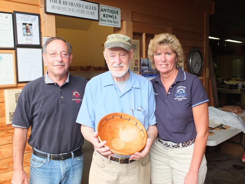 Master woodturner Lou Landry donates a handcrafted bowl to the Boothbay Charities Classic for the third consecutive year. Pictured from left are Mike Feldman, chairman of Special Olympics Maine, Lou Landry and Brenda Blackman, co-chairman of the Charities Classic. Landry's woodworking has spanned over 50 years. His studio, Ocean Point Woodturning on Van Horn Road, features unique bowls and vases, both segmented and unsegmented wood composites consisting of many colors and textures. This year, Landry's bowl 