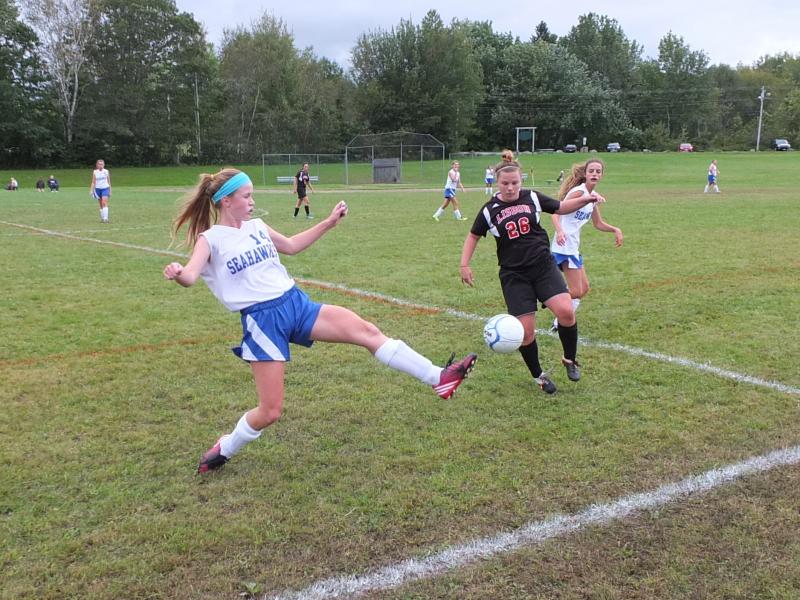 Sinead Miller scrambles to keep the ball inbounds against a Lisbon defender. Miller scored two goals in the home opener on September 16. RYAN LEIGHTON/Boothbay Register