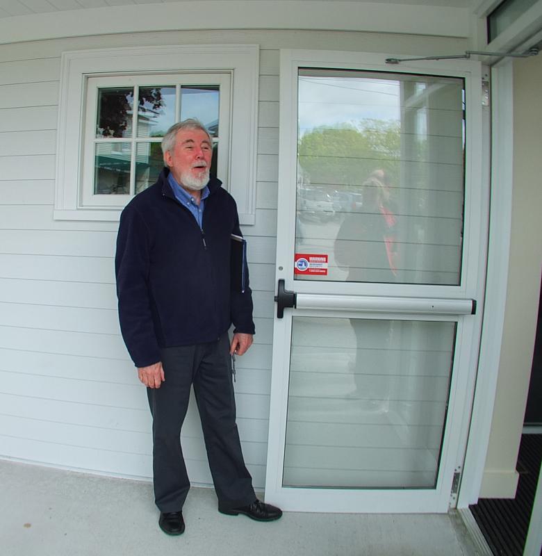 TIM McFADDEN, the executive director of the Boothbay Harbor Memorial Library, opens the new door to library volunteers on June 24. SUZI THAYER/Boothbay Register