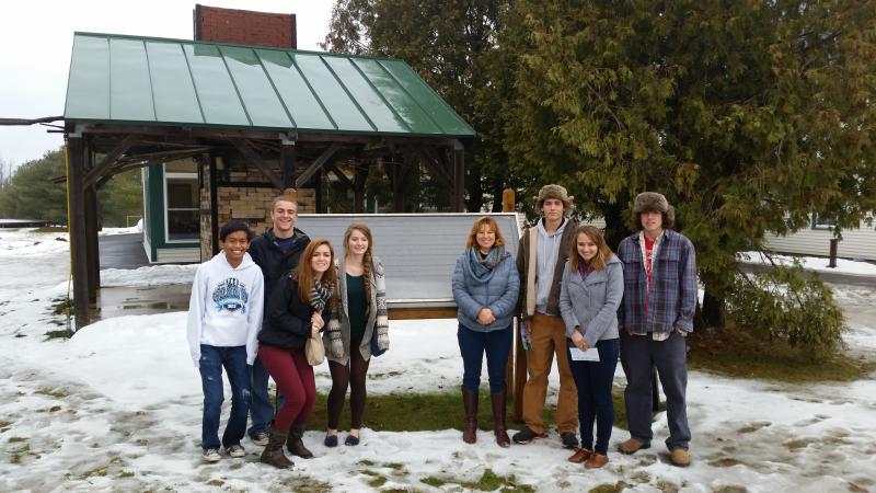 Students stand in front of a Unity College solar panel, which was originally installed at the White House by President Jimmy Carter, and then moved to the college by the Reagan administration and Unity staff. From left are Kyle Alamo, Zach Vise, Ashley Reed, Maya Schwehm, College Access Counselor Kerrin Erhard, Abel Bryer, Anna Baumm and Sherman Brewer. Courtesy of Kerrin Erhard