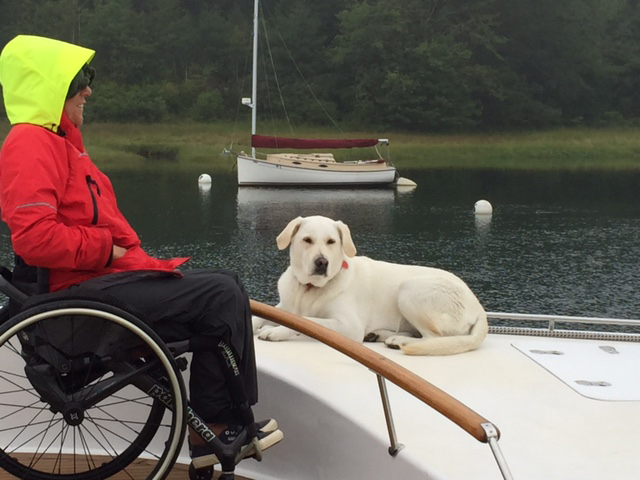 Deborah Mellen and her faithful companion, Winter, keep watch at the bow of Impossible Dream. Courtesy of Harry Horgan