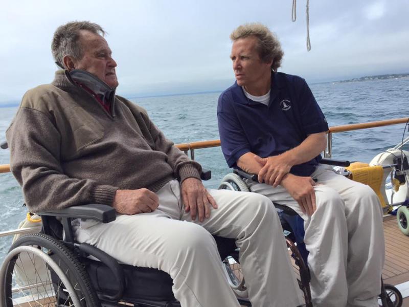 Harry Horgan and former president George H. W. Bush have a heart-to-heart on the deck of the Impossible Dream. Courtesy of Harry Horgan