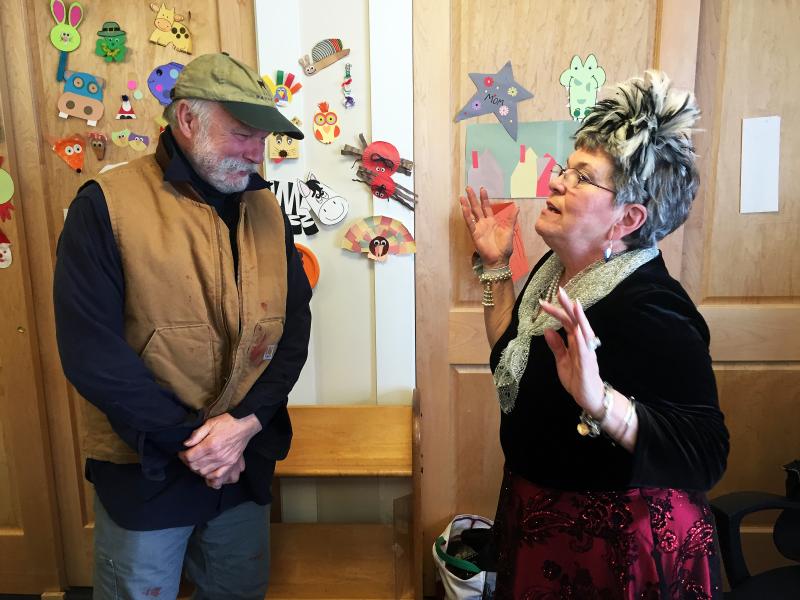 Local photographer Bob Mitchell listens to a story told by an animated Mary Pinkham. SUZI THAYER/Boothbay Register