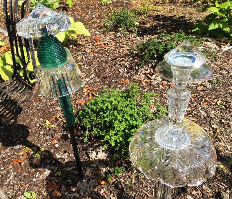 Some of the delightful garden ornaments that grace the courtyard of Carriage House Gardens. SUZI THAYER/Boothbay Register