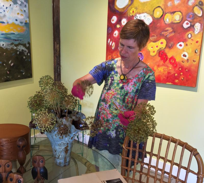 Lucia Droby arranges flowers in one of the vases by Rhode Island ceramic artist, John Fazzino. SUZI THAYER/Boothbay Register