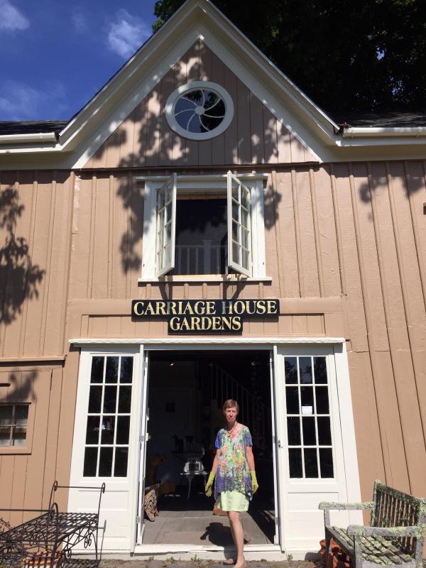 Lucia Droby in the doorway of her Wiscasset business, Carriage House Gardens. SUZI THAYER/Boothbay Register