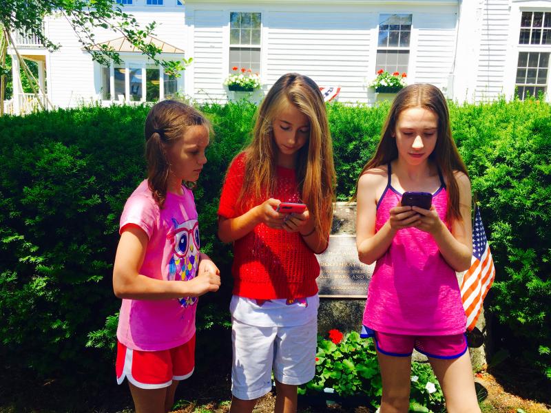 A trio of Pokemon Go players in front of a PokeStop, the war memorial at the Boothbay Harbor Memorial Library. MATTHEW STILPHEN/Boothbay Register