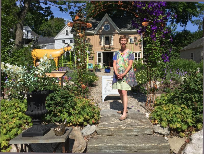 Lucia Droby stands in the courtyard of her Wiscasset business, Carriage House Gardens. SUZI THAYER/Boothbay Register