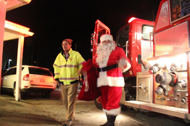 Boothbay Fire Chief Dick Spofford escorts Santa. DIANE DORBIN/Boothbay Register Santa ,Spofford