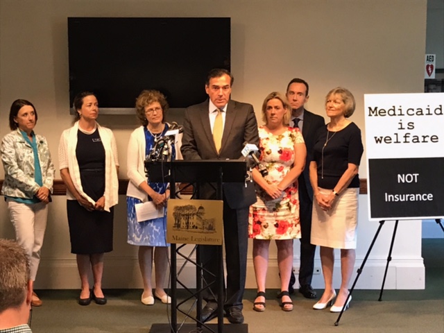 State Rep. Stephanie Hawke (R-Boothbay Harbor), third from right, listens as former Maine GOP Chairman Rick Bennett speaks at an Augusta press conference explaining why he and four state legislators sent a letter to the Secretary of State’s office regarding changing wording on this fall’s Medicaid expansion referendum question. Courtesy photo
