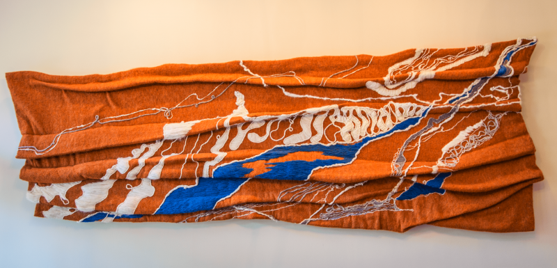 “Mountain Stream” Nancy Hemenway Barton - blue, white and gray embroidery on orange wool. 1996. 3’10 inches x 10.5 inches Nancy Hemenway Barton