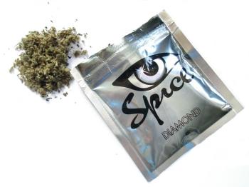 Spice is legally sold in bright packages marked “not for human consumption.” Herbal mixtures laced with chemical additives are smoked for a marijuana-like high with some unintended consequences. Below, Amy and Mike Preston, pictured here at the Alna General Store, are waging a private campaign to raise awareness about the legal high that claimed the life of their 18-year-old nephew in May.