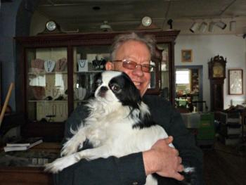 Tony Heyl comforts a stressed-out Hoover, who may be wondering why his comfy bed under one of the cases has vanished. KATRINA CLARK/Boothbay Register