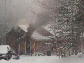 A log cabin fire rages at a Marston Road residence on February 5. RYAN LEIGHTON/Boothbay Register