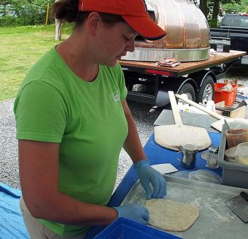 KATIE McLELLAN presses out a fresh dough crust for a pizza. SUZI THAYER/Boothbay Register