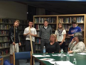 Members of the “Making and Marketing” class at BRHS present their company, dubbed the “Boothbay Paddle Company” to the CSD School Committee on Nov. 4. From left are Joe Paolillo (design and engineering), Nick McCullough (quality control), Camden Spear (marketing), Anna Baumm (marketing), and Nick Gorey (finance). Sitting are committee members Stephanie Hawke and Sandy Paxson. KATRINA CLARK/Boothbay Register
