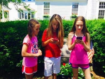 A trio of Pokemon Go players in front of a PokeStop, the war memorial at the Boothbay Harbor Memorial Library. MATTHEW STILPHEN/Boothbay Register