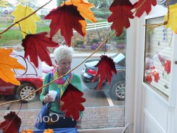 Pam O’Connor checks out the decorated store fronts at the Harbor Crawl in Boothbay Harbor. RYAN LEIGHTON/Boothbay Register 