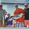 Walter Moulaison and his son, Jacob, center, caught a 47-inch striper aboard the Redhook on August 19. Courtesy of Mark Stover