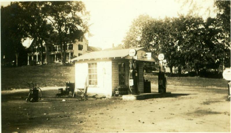 Colby's Filling Station, at the corner of Townsend Avenue and Union Street, in 1936. The present Thistle Inn on Oak Street is up the hill on the left. Courtesy of Kenny Poole. Below, Peanut Lewis' Calso Gas Station in 1953, with the Opera House on the left and Oak Street above.