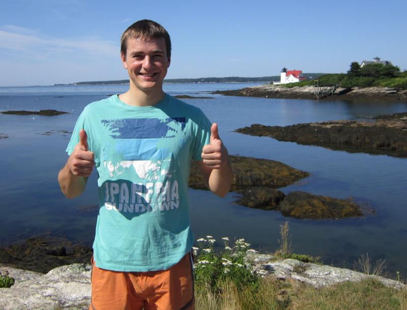 Quester Edvinas Lupieka strikes a happy pose. Hendrick’s Head Lighthouse, one of the places on the quest, is behind him. Below, questers Lupieka, foreground, and Joshua Edwards look at a historic map of the Boothbay region at the Balmy Days Museum. Courtesy of Cheryl Gaynore Quester Edvinas Lupieka strikes a happy pose. Hendrick’s Head Lighthouse, one of the places on the quest, is behind him.