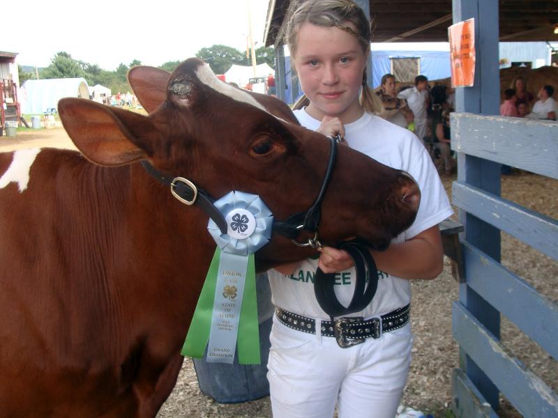 Nicole Jewett of Wiscasset and 15-month old Rosie, a Holstein heifer, celebrate their win in the Jr. Holstein division of the Open Show at the Union Fair. Below, 4H dairy goat club members show off the trophies they won at the Union Fair. From left are Caitlyn Spear with Lexy, who won Supreme Junior Doe, Nichole Jewett with Libby, and Saorica Bogart with Lindy. Courtesy of Deidre Jewett Nicole Jewett of Wiscasset and 15-month old Rosie, a Holstein heifer, celebrate their win in the Jr. Holstein division of the Open Show at the Union Fair.