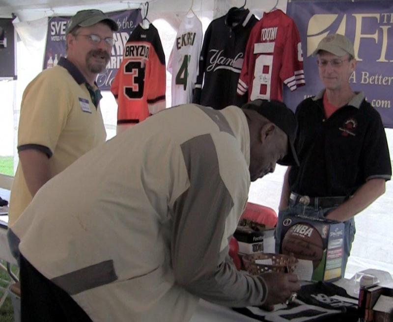autographs a jersey with auction organizers Tom Erskine and Bob Umberfield during the sports auction at the Boothbay Railway Village. The auction raised $18,000 for Special Olympics Maine. Courtesy of Jonne Trees/BRCTV Channel 7 autographs a jersey with auction organizers Tom Erskine and Bob Umberfield during the sports auction at the Boothbay Railway Village. The auction raised $18,000 for Special Olympics Maine. Courtesy of Jonne Trees/BRCTV Channel 7
