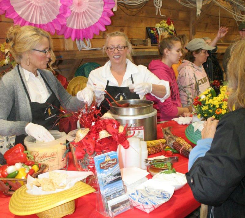 Kelly Flynn, left, and Holly Stover dish out Brown's Wharf first-place chili, made by Micah Jones Kelly Flynn, left, and Holly Stover dish out Brown's Wharf first-place chili, made by Micah Jones