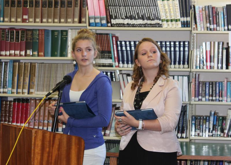 Sophomore Maya Schwehm, left, and junior Courteney Chaney represent The Heritage Foundation in this year’s debate. Here the students give their opening remarks, bolstered by an iPad chock full of data. Below: Mark Gorey, left, and Rotarian Bill Bailey listen and take notes during a student presentation. Third photo: Debaters and the audience, including Principal Dan Welch, listen intently to opening remarks on October 26. SUE MELLO/Boothbay Register Sophomore Maya Schwehm, left, and junior Courteney Chaney represent The Heritage Foundation in this year’s debate. Here the students give their opening remarks, bolstered by an iPad chock full of data.