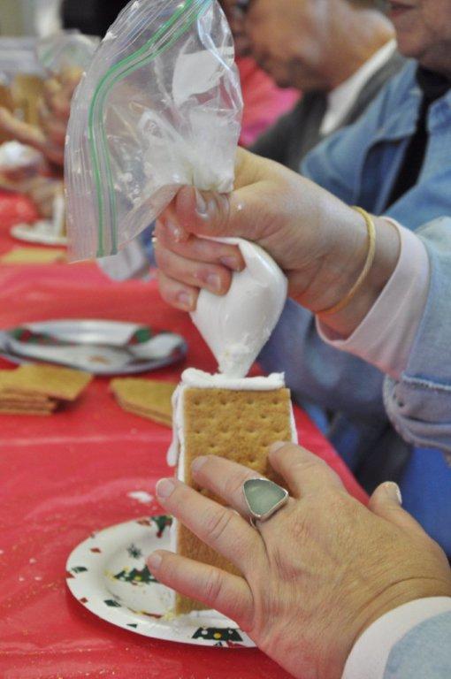 De Amplo constructs a gingerbread house. BEN BULKELEY/Boothbay Register De Amplo constructs a gingerbread house. BEN BULKELEY/Boothbay Register