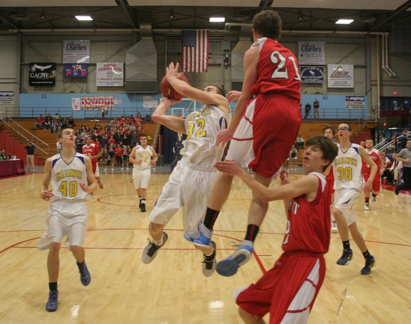 Anthony DiMauro slices through the lane and past the leaping Dale Peaslee to score two of his game-high 19 points. BELOW: On this fourth quarter shot, senior point guard Anthony DiMauro went over the 1,000 point mark in his career. BOTTOM: Junior guard Andrew Hallinan goes high to score two of his 12 points against Wiscasset. KEVIN BURNHAM/Boothbay Register Anthony DiMauro slices through the lane and past the leaping Dale Peaslee to score two of his game-high 19 points. KEVIN BURNHAM/Boothbay Register