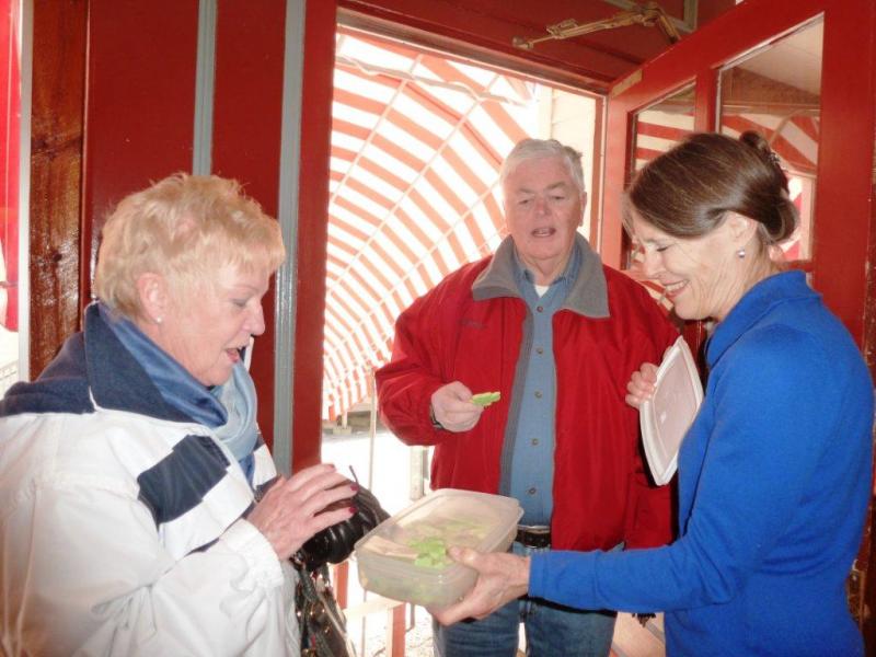 Nancy Gilchrist, right, offers a St. Patrick’s Day cookie to Joyce Tomecko of Rhode Island while John Appleton looks on. KATRINA CLARK/Boothbay Register Nancy Gilchrist, right, offers a St. Patrick’s Day cookie to Joyce Tomecko of Rhode Island while John Appleton looks on. KATRINA CLARK/Boothbay Register