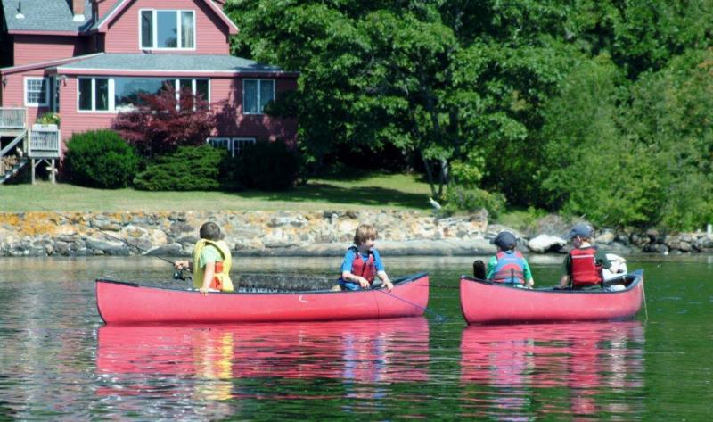 Participants in the Boothbay Region YMCA's half-day fishing camp. Below: One of Camp Knickerbocker's safety drill exercises: learning to swamp a canoe. Courtesy of Earl Brewer Courtesy of Earl Brewer Participants in the Boothbay Region YMCA's half-day fishing camp.
