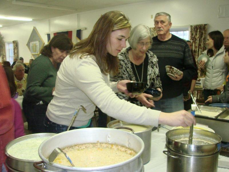 Kelsy Hartley decides on one of the 20-plus soups, chowders and stews donated for this year's fundraising event. LISA KRISTOFF/Boothbay Register Kelsy Hartley decides on one of the 20-plus soups, chowders and stews donated for this year's fundraising event. LISA KRISTOFF/Boothbay Register