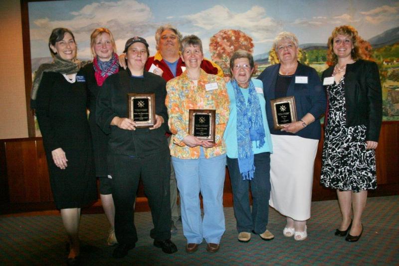 Standing with the winners at the Chamber's annual awards dinner at Fisherman's Wharf May 22 are Pamela Riley, left, president of the Chamber's board of directors, and Catherine Wygant-Fossett, right, executive director. Representing the three award winners are, from left, Elena and Ralph Smith and Boat House Bistro co-owner and chef Karin Guerin of Boothbay Harbor Restaurant Group, winner of the Community Improvement Award; Kim Martin and Mim Martin of Eventide Specialties, winner of the Business Improvement Award; and Sue Burge of the Set for Success program, winner of the Community Service Award. KEVIN BURNHAM/Boothbay Register Standing with the winners at the Chamber's annual awards dinner at Fisherman's Wharf May 22 are Pamela Riley, left, president of the Chamber's board of directors, and Catherine Wygant-Fossett, right, executive director. Representing the three award winners are, from left, Elena and Ralph Smith and Boat House Bistro co-owner and chef Karin Guerin of Boothbay Harbor Restaurant Group, winner of the Community Improvement Award; Kim Martin and Mim Martin of Eventide Specialties, winner of the Business Improvemen