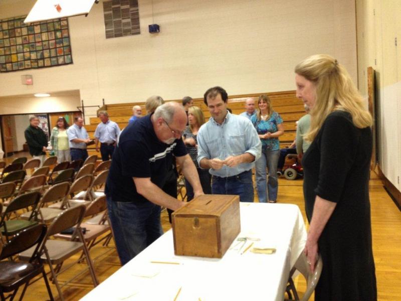 Article 14, concerning additional local funds exceeding the State's Essential Programs and Services, was the only written/secret ballot. Below: Boothbay Town Manager Jim Chaousis questions an increase in the CSD 2013-2014 budget. LISA KRISTOFF/Boothbay Register Article 14, concerning additional local funds exceeding the State's Essential Programs and Services, was the only written/secret ballot. LISA KRISTOFF/Boothbay Register