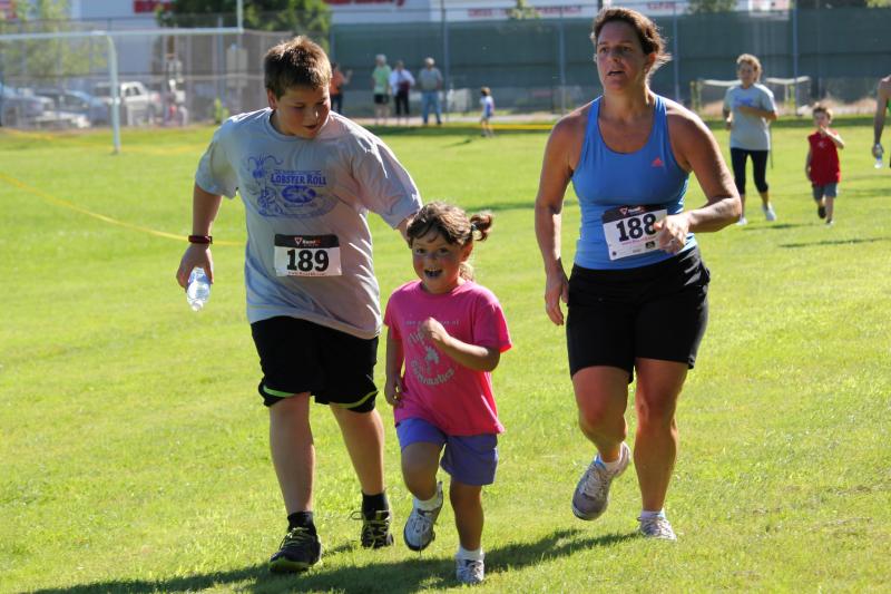 Running may not sound fun to some, but this young girl’s face says it all as she approaches the finish line during the kids’ fun run. SUE MELLO/Boothbay Register Running may not sound fun to some, but this young girl’s face says it all as she approaches the finish line during the kids’ fun run. SUE MELLO/Boothbay Register