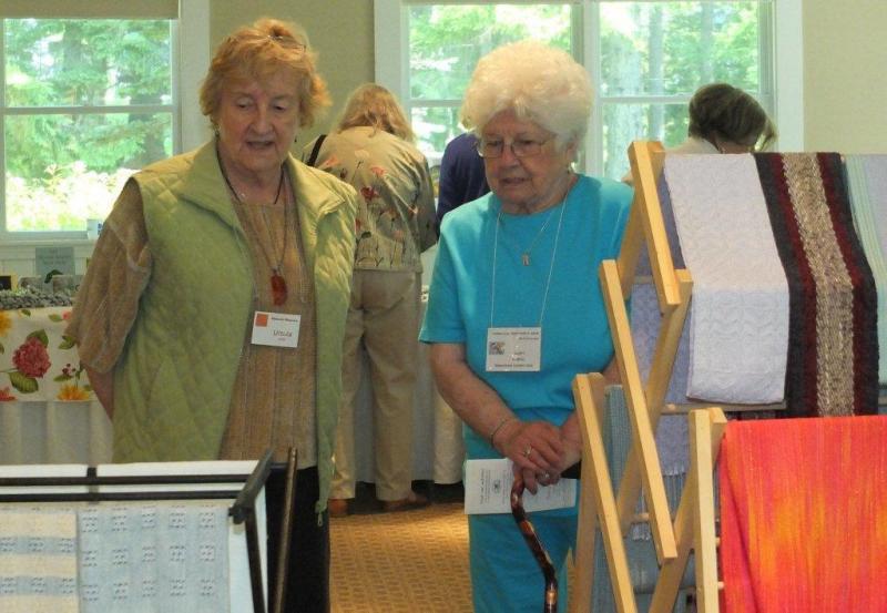 Ursula Smith, left, talks about her woven works at the Vendor's Market. LISA KRISTOFF/Boothbay Register Ursula Smith, left, talks about her woven works at the Vendor's Market. LISA KRISTOFF/Boothbay Register