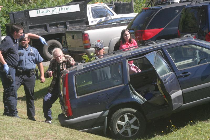 The driver of this Volvo involved in the accident at the Irving gas station, Joseph Creighton of Boothbay Harbor, walks around the car while being directed to an ambulance by one of the attendants at the scene. Creighton was later charged with operating under the influence. KEVIN BURNHAM/Boothbay Register The driver of this Volvo involved in the accident at the Irving gas station walks around the car while being directed to an ambulance by one of the attendants at the scene. KEVIN BURNHAM/Boothbay Register