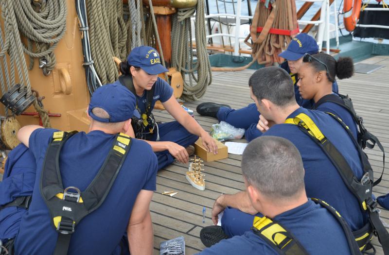 Crew member Lawren Hill-Hand teaches seamanship to OCs on the forecastle of the Eagle.
