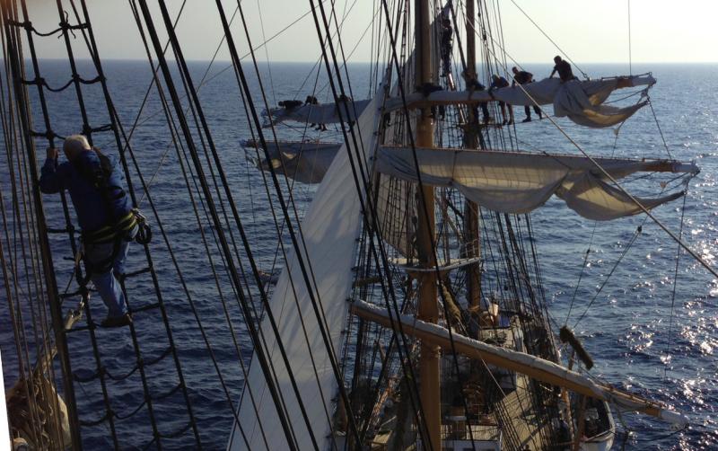 Crew climb high into the 147-foot tall masts of the Eagle to unfurl the sails before hoisting them. (Photo by Boatswain’s Mate Shelbie Smart)