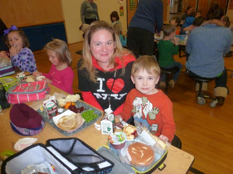 Crystal Campbell enjoys a hot BRES lunch while her son, Kolton, munches on the lunch he brought from home. KATRINA CLARK/Boothbay Register