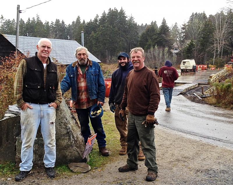 Skip Rideout, left, the engineer in charge of the construction of the Pratts Island bridge, is shown here at the site with Al Morton, Robbie Campbell and Larry Colcord. Courtesy of Larry Colcord