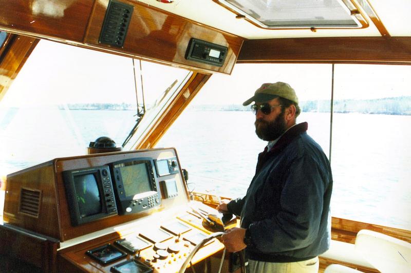 Captain Mark Colby piloting a yacht. Courtesy of Mark Colby