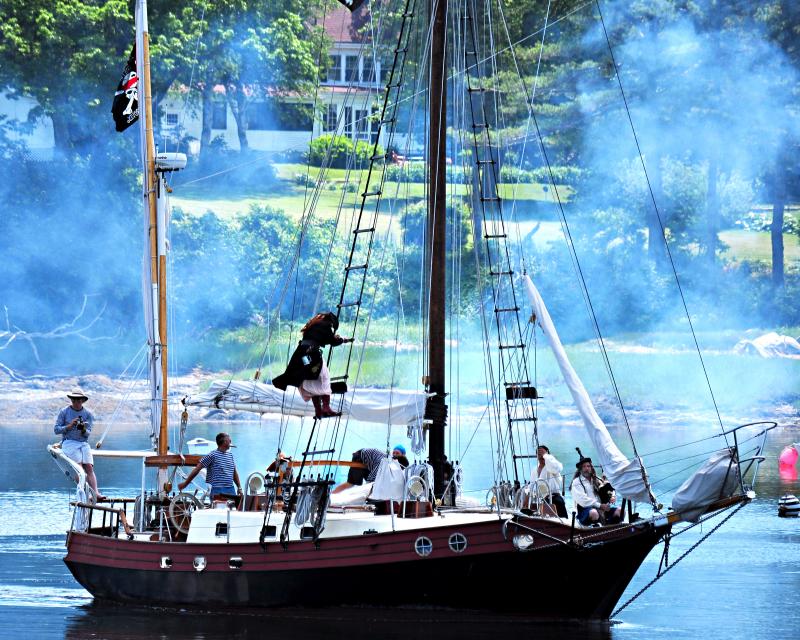 Pirate Vessel S/V Must Roos: The pirate ship S/V Must Roos sails up river loaded with pirates ready to invade the in-town areas of Damariscotta and Newcastle during a past Damariscotta River Pirate Rendezvous. The vessel is armed with six cannon, and sailing aboard her is one of the many activities in which recruits for the Pirates of the Dark Rose can participate. Courtesy of Michael Morrison