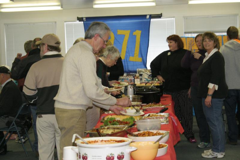 Bob Boyd, after buying his raffle tickets, fills his plate with food. KEVIN BURNHAM/Boothbay Register