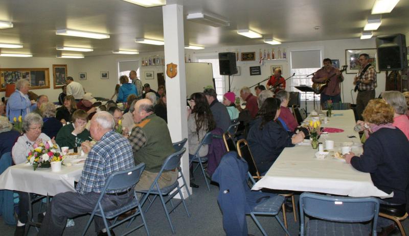 While the musicians play in the corner, attendees enjoy their plates of food at the Marston family fundraiser at the Boothbay Fire Station on Sunday, March 2. KEVIN BURNHAM/Boothbay Register
