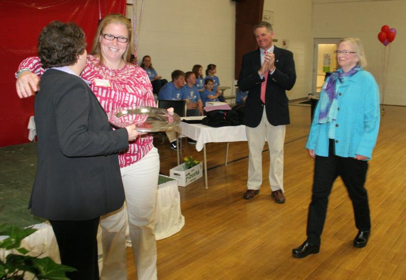 Maddie Rideout receives a silver platter and hug from Doris Welch, left, as Maddie and her mother, Pam Baldwin, right, are honored for their work as co-chairs of the Y’s annual fund drive. KEVIN BURNHAM/Boothbay Register Rideout