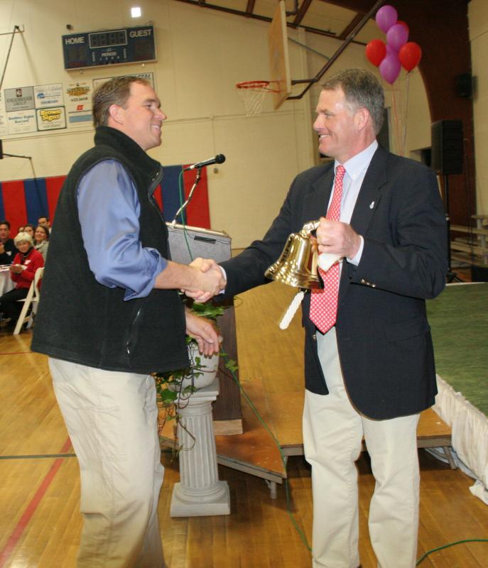 Andrew Morley, left, receives a handshake and gold bell after being honored as Volunteer of the Year by Y Executive Director Andy Hamblett. KEVIN BURNHAM/Boothbay Register Morley